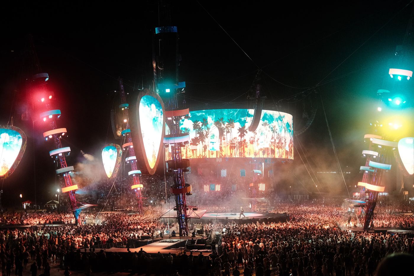 Crowd in front of a lit concert stage